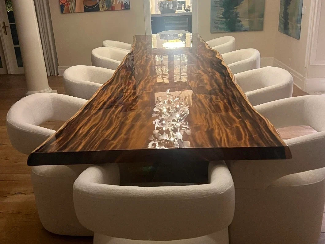 Long natural-edge wood dining table with upholstered chairs