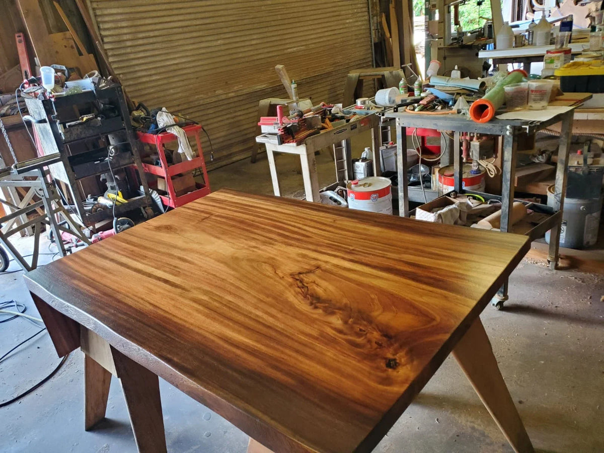 Wood tabletop supported on trestles in a workshop