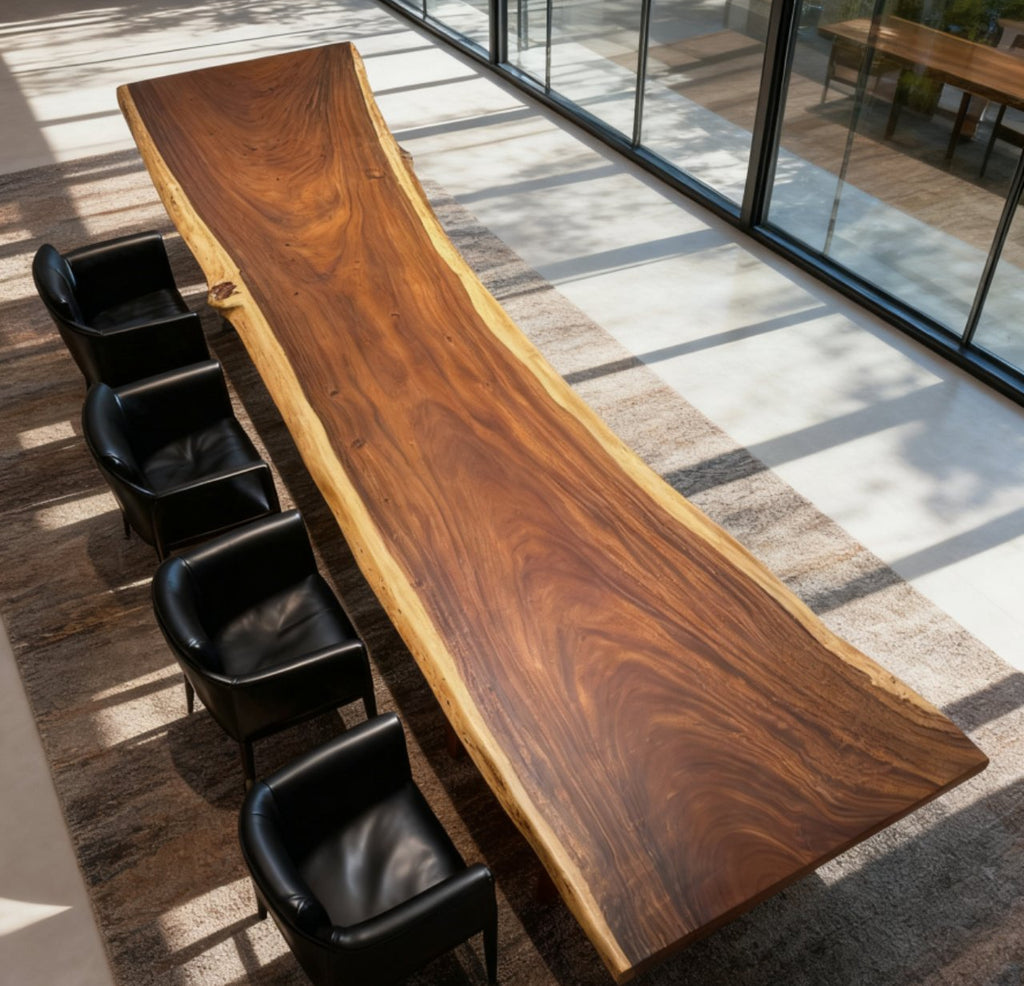 Long wooden table with black chairs in a modern indoor setting