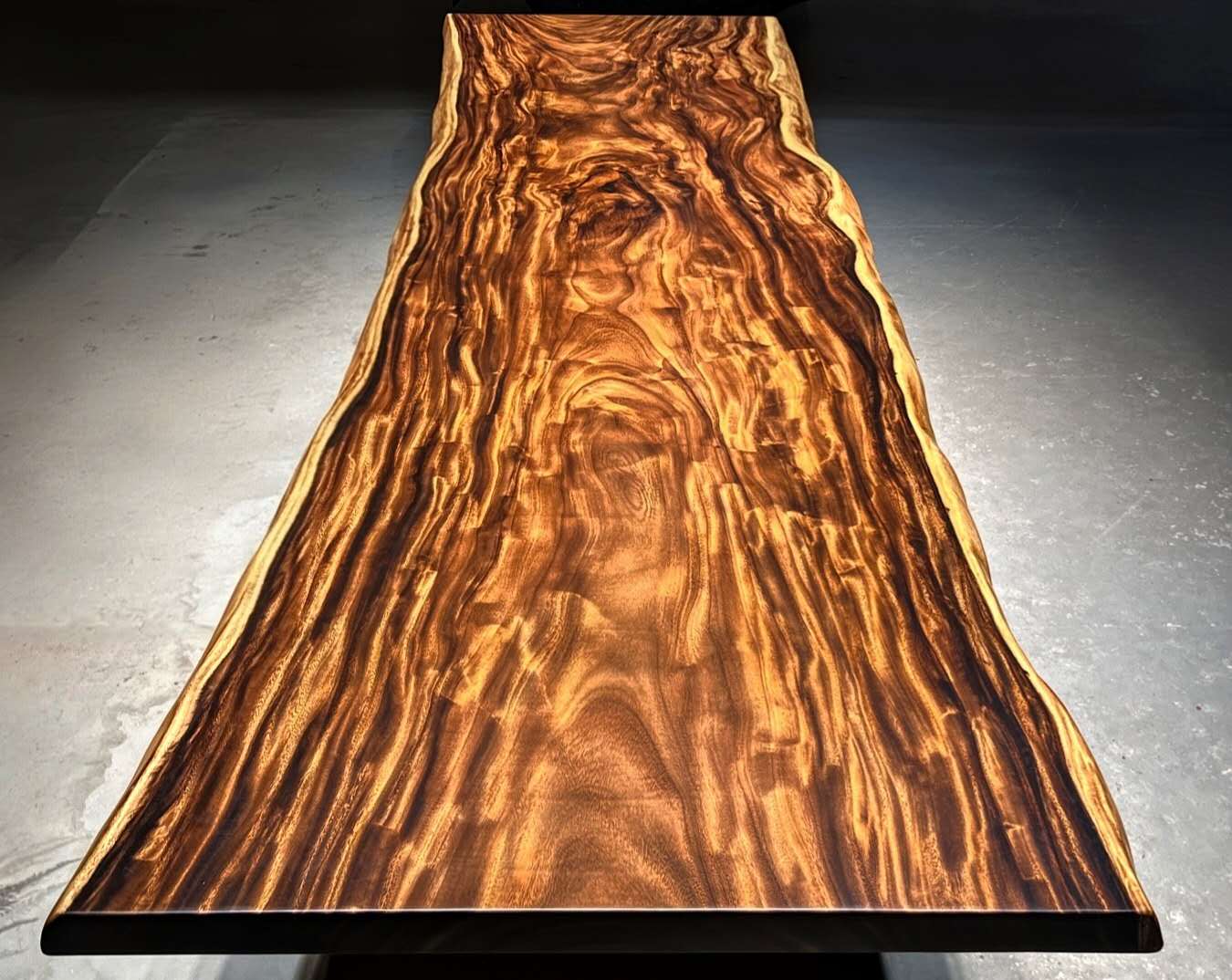 Wooden table with a prominent grain pattern on a gray background