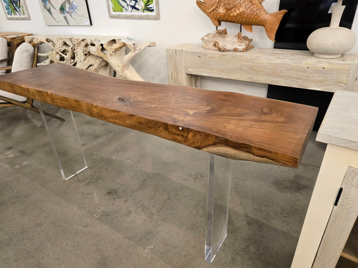 Wood console top resting on clear acrylic supports