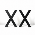 Two large black 3D letters 'X' standing side by side on a white surface against a white background.