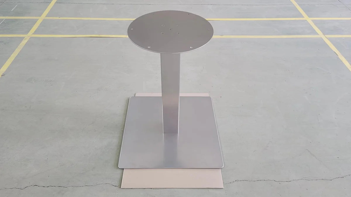 Finished metal pedestal table base with a round mounting plate and square floor plate